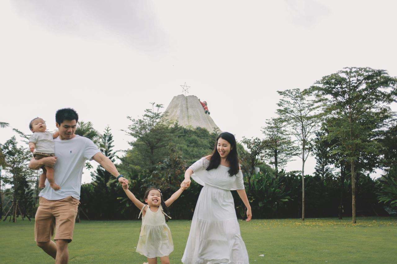 Family walking together on grassy field