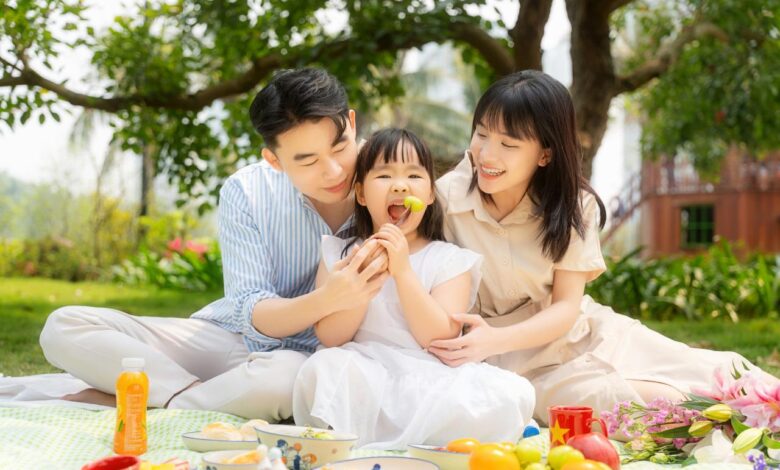 A happy family enjoying a picnic in a park.